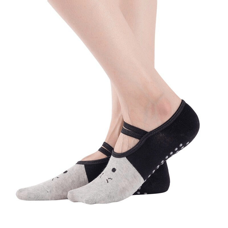 Woman wearing cartoon cat print anti-slip yoga socks with black and gray design, ideal for stability and comfort during workouts.